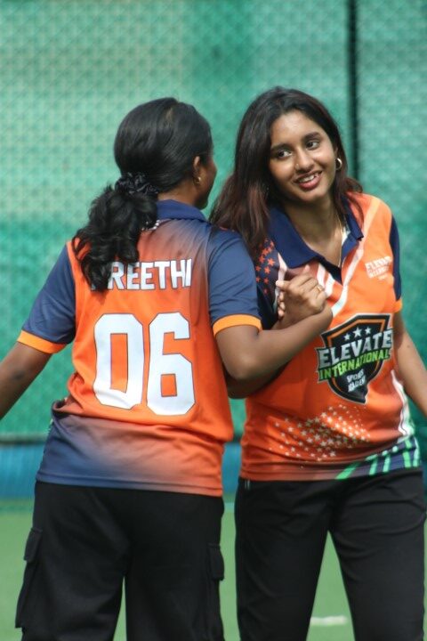Female cricket team showing teamwork during match Female cricket team showing teamwork during match