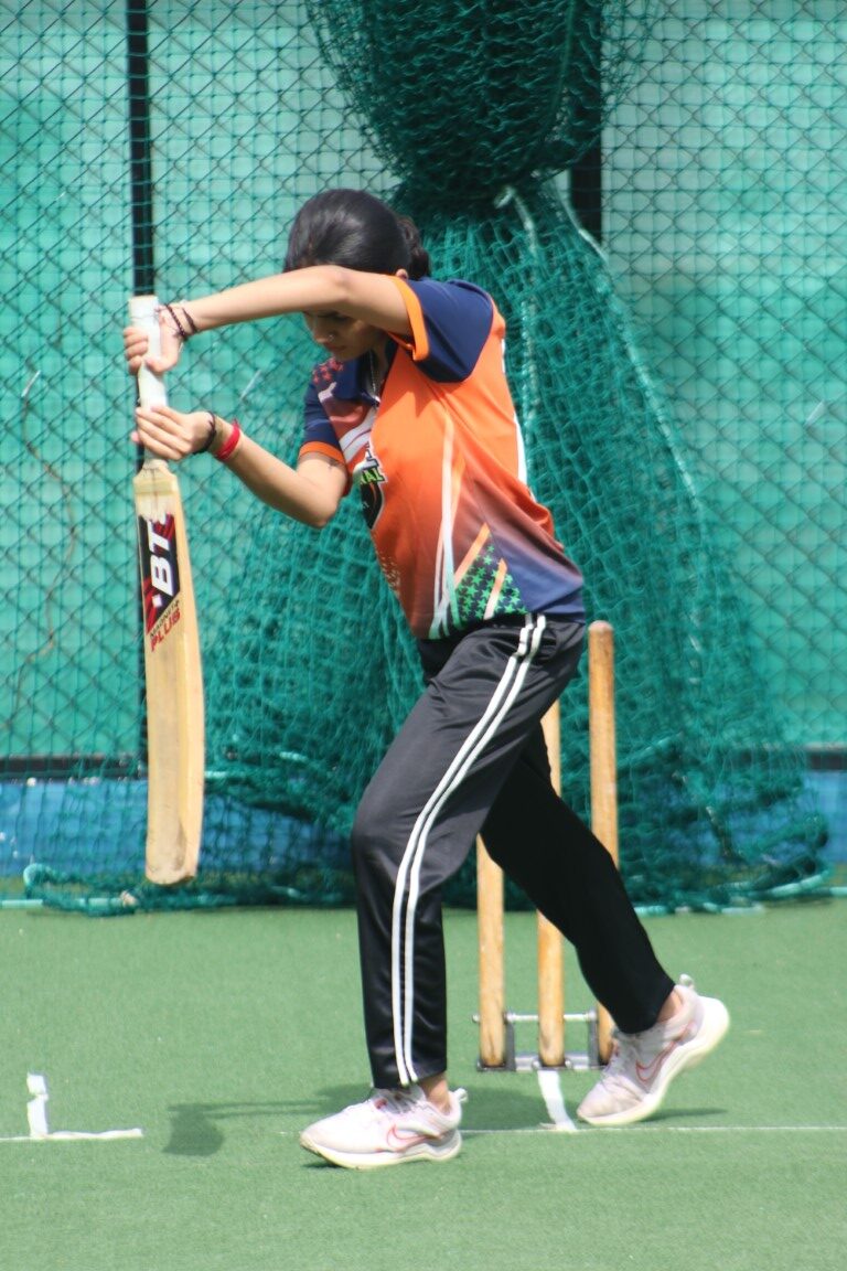 Female cricket players practicing batting technique Female cricket players practicing batting technique